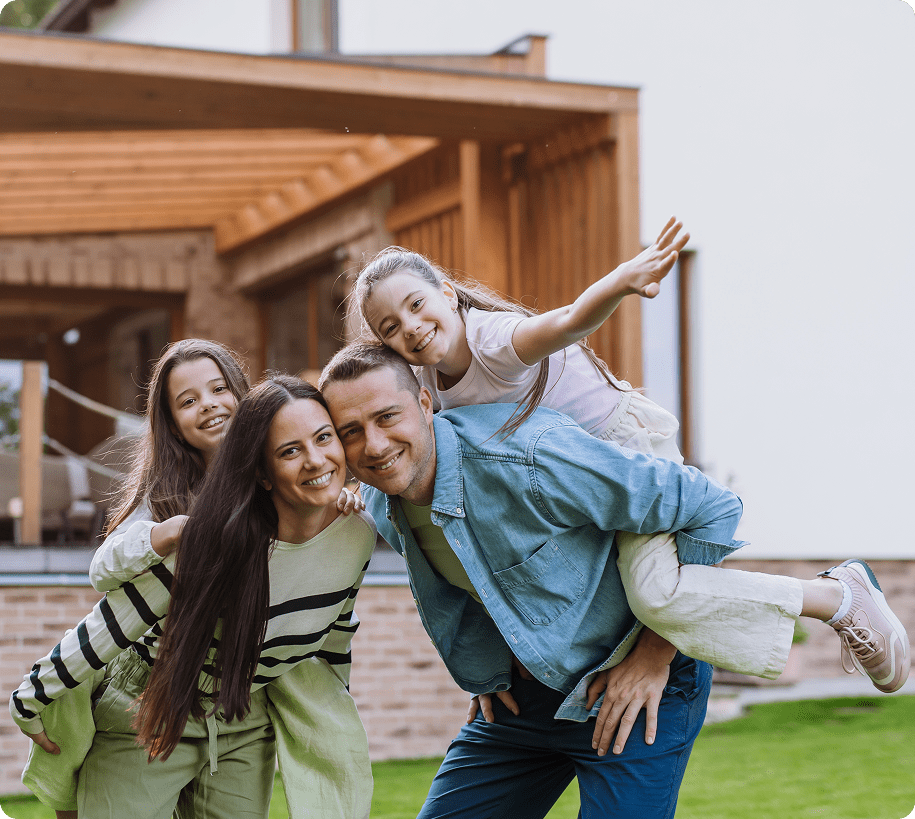 Happy family posing together in front yard.