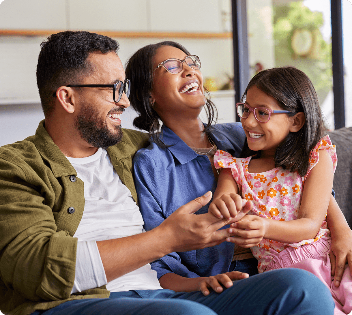 Family laughing together on the couch.